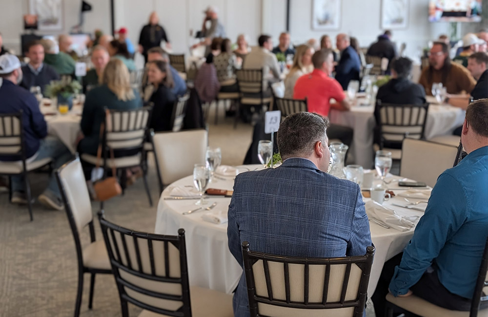 Wide shot of attendants at a formal dinner