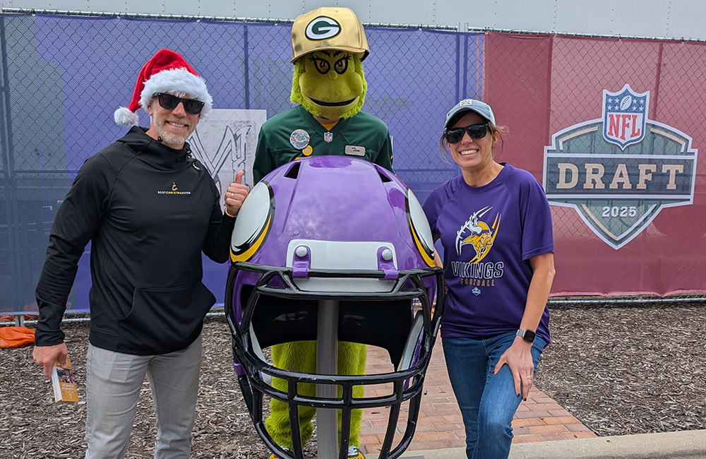 Beau and Kayla with mascot and football helmet